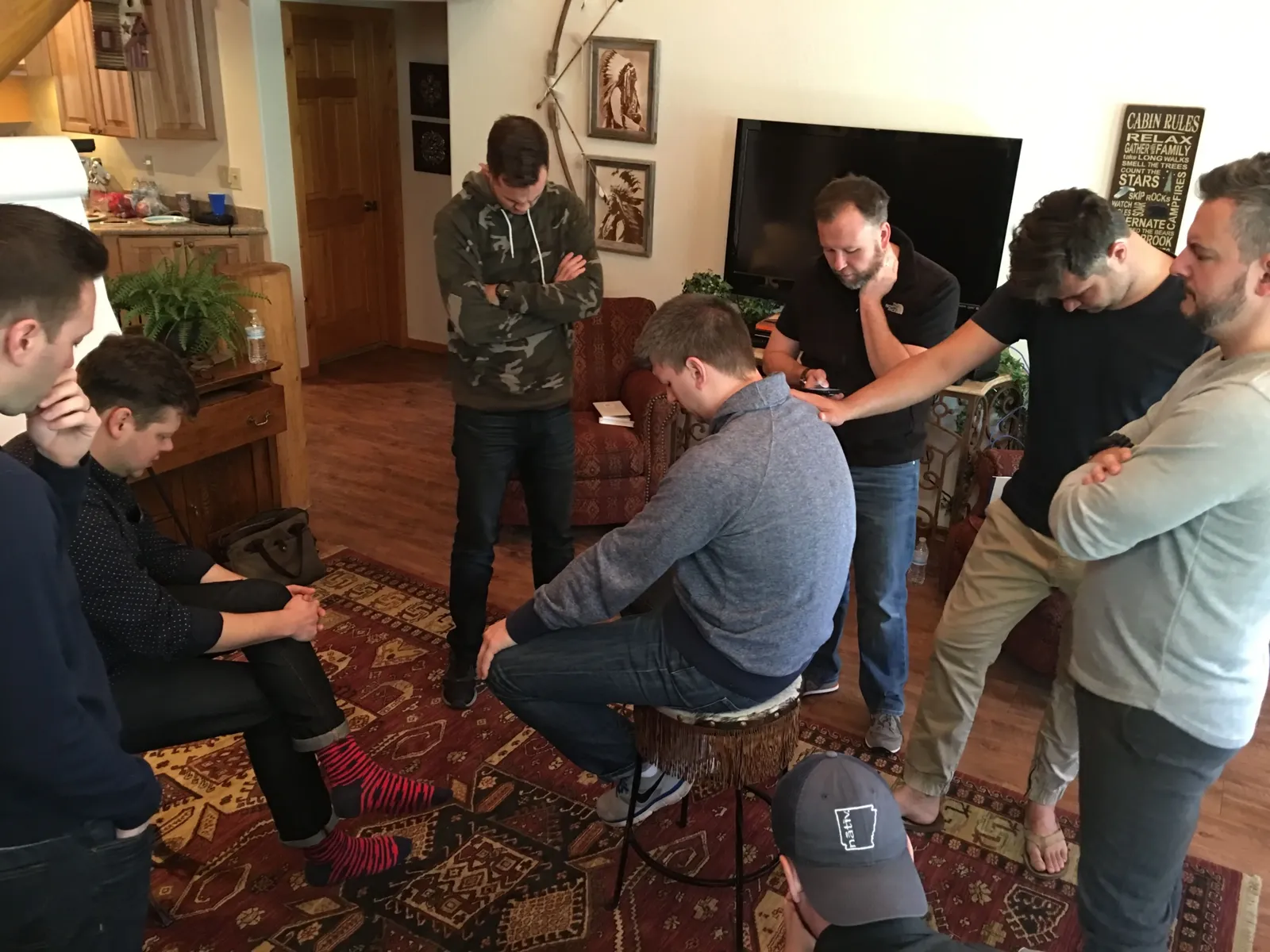 Billy Patterson praying with a group of pastors